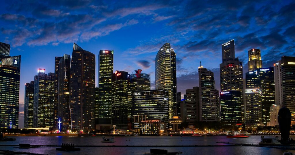 Spectacular view of Singapore's skyline with illuminated skyscrapers against a twilight sky.